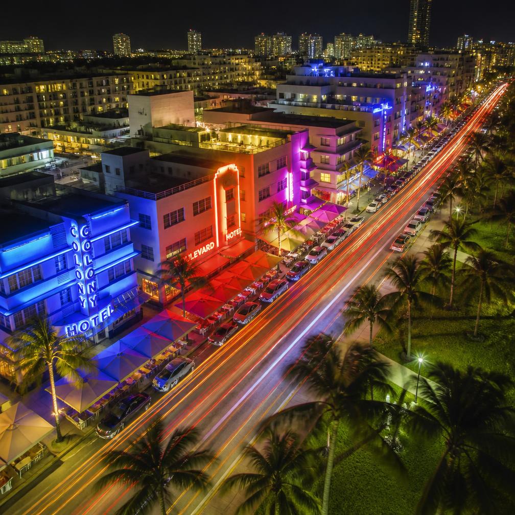 Aerial night shot of Miami Ocean Drive neon lights with long exposure car streaks